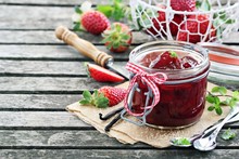 Homemade Delicious Strawberry Jam On A Rustic Wooden Table