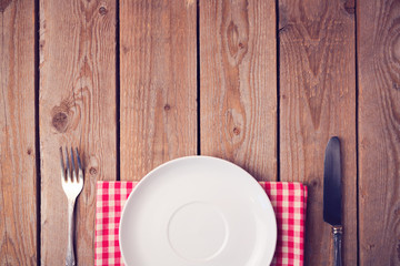 Poster - Wooden table with empty plate. View from above