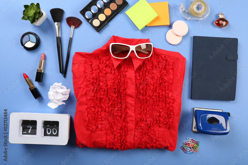 Modern female clothing and accessories on color background