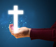 © ra2 studio - Glowing cross in the hand of a woman