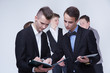 © photoniko - a group of young businessmen looking at paperwork