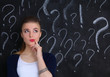 © lenets_tan - Young girl with question mark on a gray background