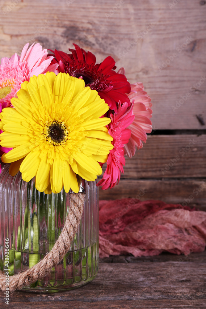 Still life with beautiful bright gerbera flowers on wooden background