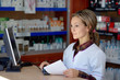 © bereta - young female pharmacist holding prescription