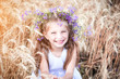 beautiful little girl  in a field of wheat