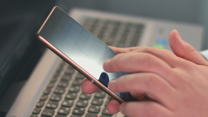 Guy typing message text on smartphone, fingers touching screen