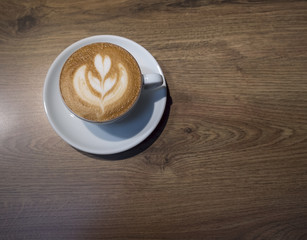 Wall Mural - Coffee cup on wooden table top view