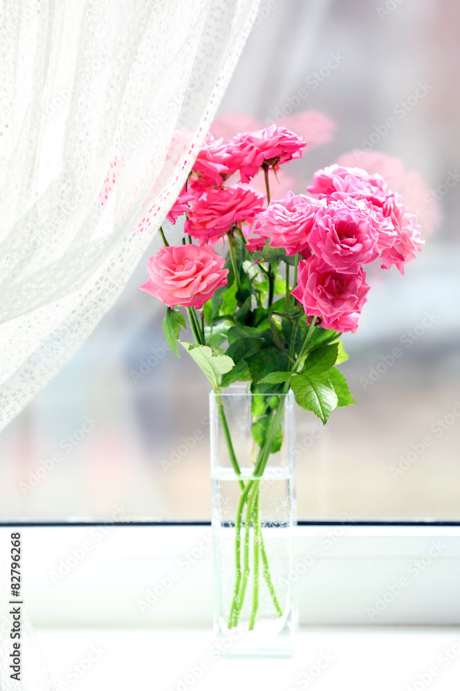 Bouquet of beautiful fresh roses on curtains background