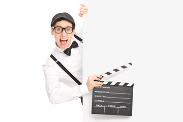 Sticker - Movie director holding clapperboard behind a panel