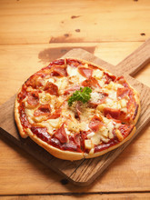 Hawaiian Pizza On Wood Plate