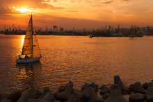 Sailing Yacht Enters Varna Harbor At The Sunset