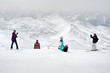 © guruXOX - Happy snowboarders and skiers enjoy on top of mountain