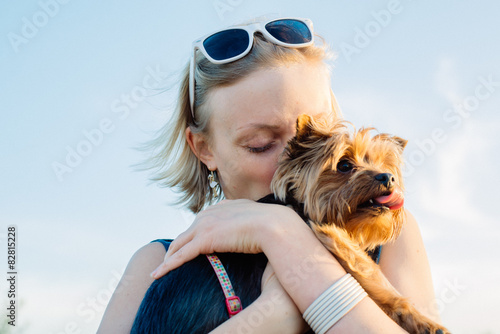Beautiful Young Happy Woman With Blonde Hair Holding Small Dog