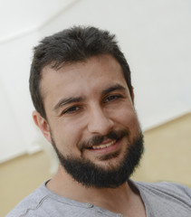 Smiling bearded man, 30s hipster style.