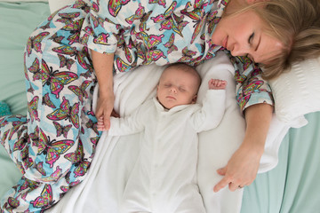 sleeping mother and two month old baby boy