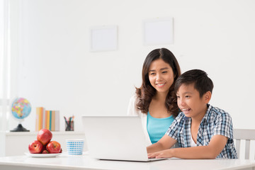mother and son at laptop