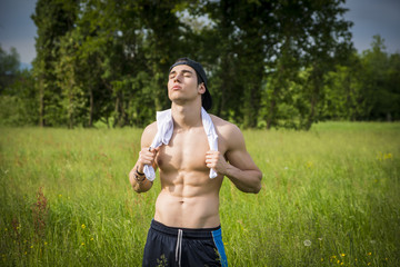 Canvas Print - Handsome shirtless fit young man at countryside, resting after