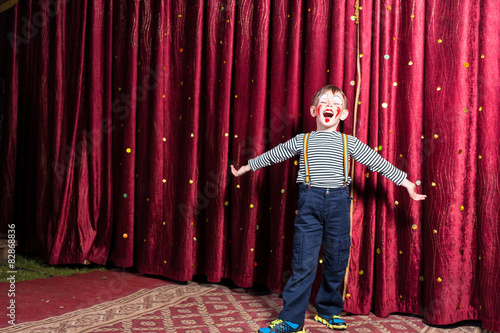 Fotografia, Obraz Adorable little boy singing on stage during a play