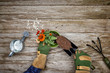 © goodmanphoto - a gardener adding soil to a potted plant