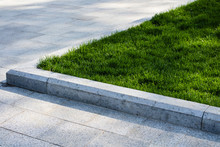 Trim The Lawn In The Park On The Sidewalk