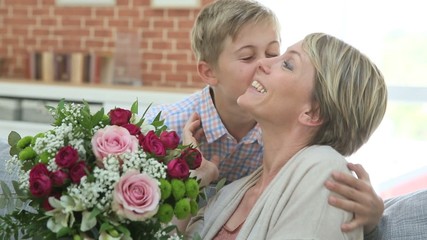 Wall Mural - Young boy giving flowers to mommy for mother's day