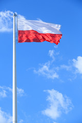 Polish flag on a background of blue sky