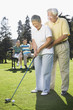 © Kris Timken/Blend Images - Senior Asian couple playing golf