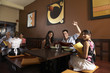© Tanya Constantine/Blend Images - Multi-ethnic friends at restaurant