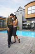 © Trevor Lush/Blend Images - Couple hugging in front of house