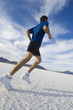 © Erik Isakson/Blend Images - Hispanic man jogging on salt flats