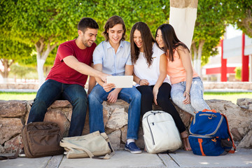 Wall Mural - Friends looking at a tablet computer