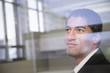 © Patrick Lane/Blend Images - Mixed race businessman looking through window
