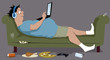 Overweight guy lying on a couch with a laptop