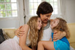 © DragonImages - Hugging lovely daughters