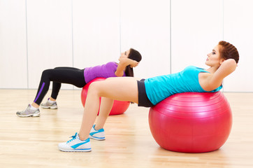 Two young girls doing gymnastic exercises