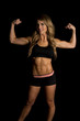 © Poulsons Photography - fit woman in black shorts and top on black flex both arms