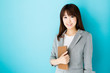 © taka - asian businesswoman on blue background