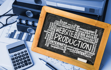 Wall Mural - website production with related word cloud handwritten on blackb