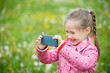 Little girl photographing with her smartphone