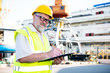 © kostyha - Engineer at a construction site in the port