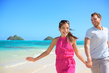 Wall Mural - Happy couple on beach running having fun on Hawaii