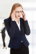 © Piotr Marcinski - Businesswoman with a head pain.