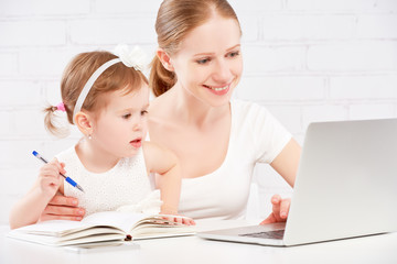 Fototapete - happy family mother and child baby at home working on computer