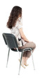 © ghoststone - back view of young beautiful  woman sitting on chair.
