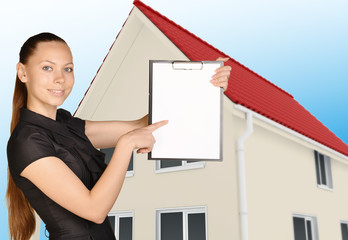 Poster - The girl on background of house holding clip board pointing