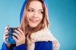 © Voyagerix - teen girl holding blue mug with hot drink