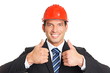 © petrdlouhy - Smiling businessman in a protective helmet shows you thumbs up