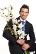 © petrdlouhy - Handsome businessman in suit holds flowers orchid
