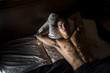 © theartofphoto - Attractive shirtless athletic young man laying in bed at night