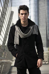 Canvas Print - Stylish Young Handsome Man in Black Coat Standing in City Center